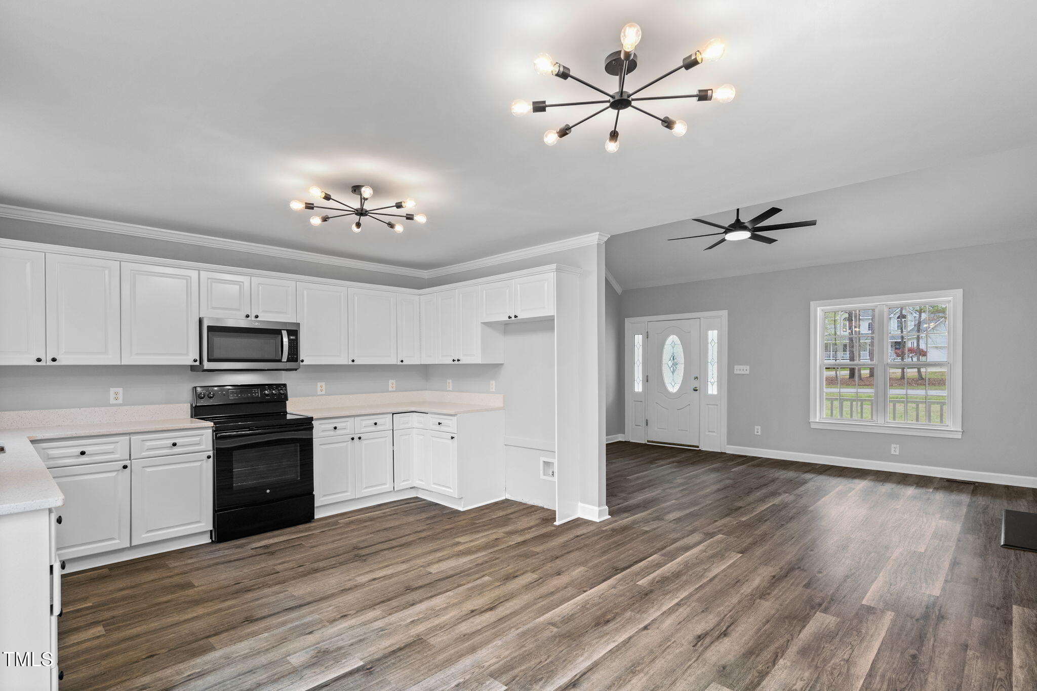 340 Castleberry Road Clayton, NC 27527 - Photo 11 of 31 a kitchen with granite countertop a stove cabinets and wooden floor