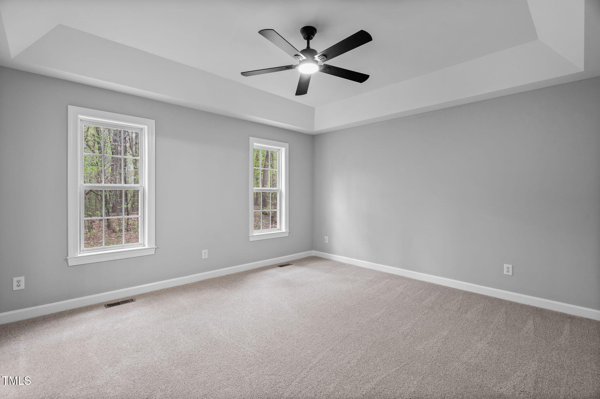 340 Castleberry Road Clayton, NC 27527 - Photo 16 of 31 an empty room with chandelier fan and windows