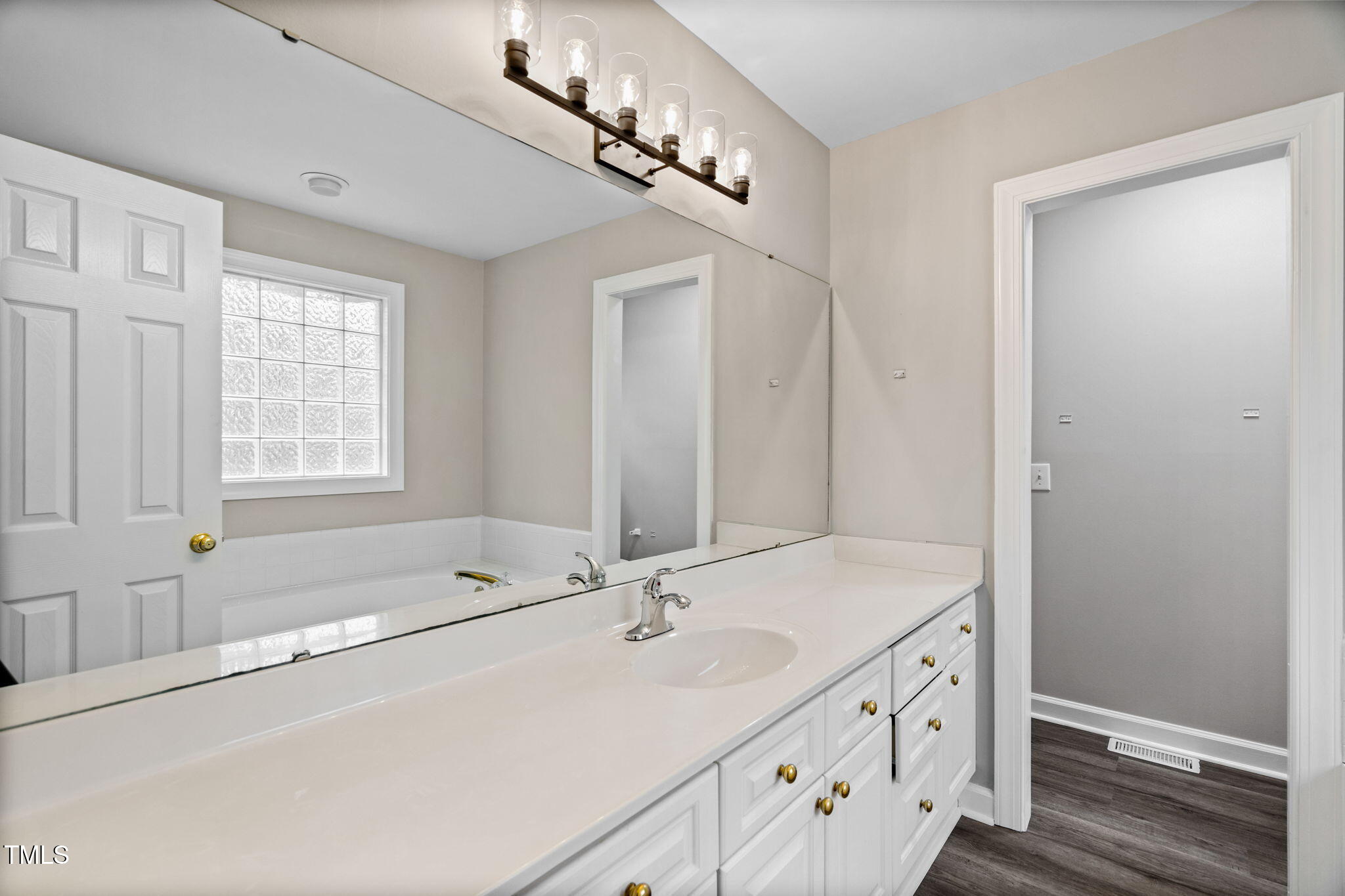 340 Castleberry Road Clayton, NC 27527 - Photo 18 of 31 a bathroom with a sink and a mirror