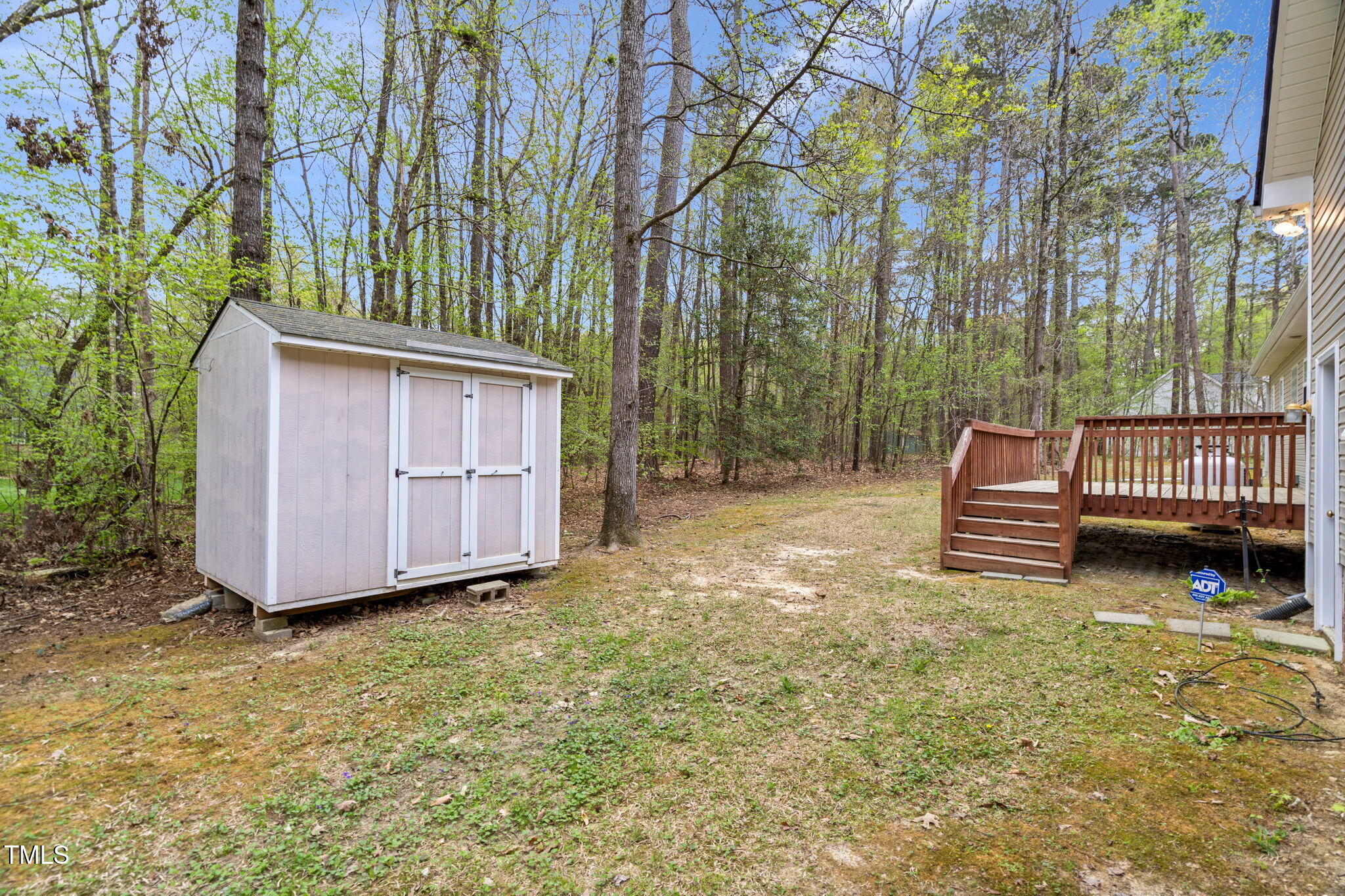 340 Castleberry Road Clayton, NC 27527 - Photo 26 of 31 a backyard of a house with a small yard and large tree