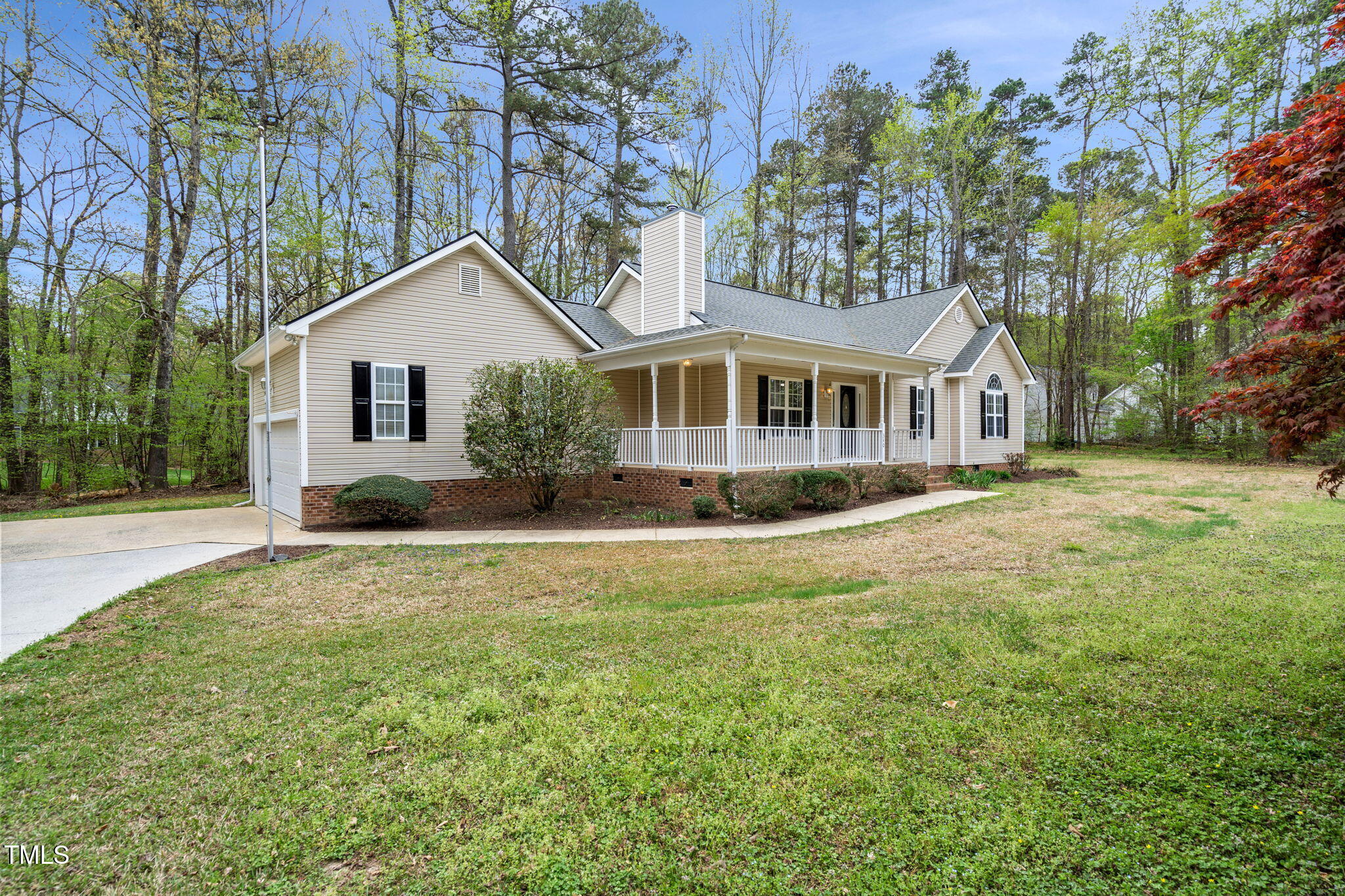 340 Castleberry Road Clayton, NC 27527 - Photo 4 of 31 a front view of a house with a garden and lake view