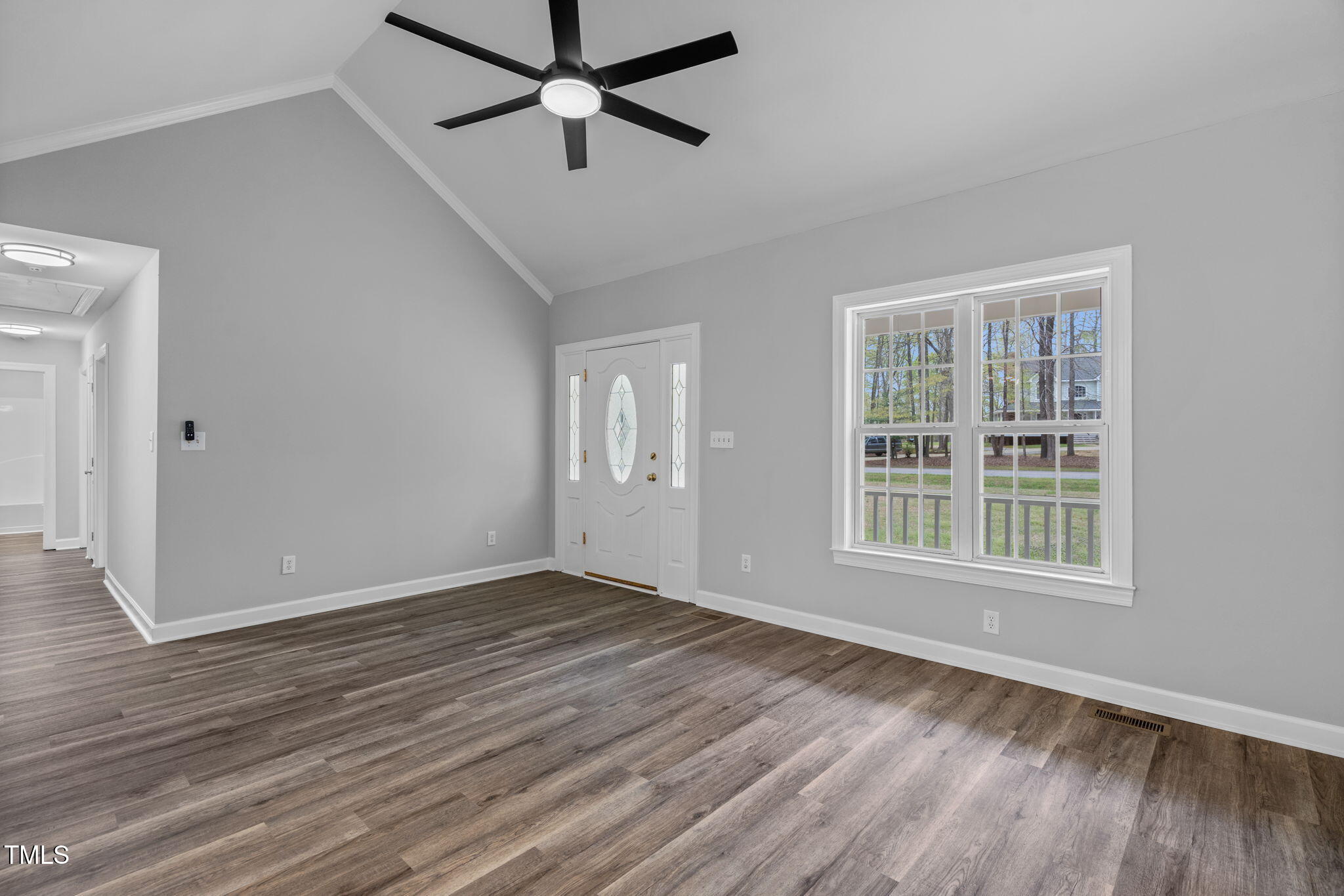 340 Castleberry Road Clayton, NC 27527 - Photo 8 of 31 a view of empty room with wooden floor and fan