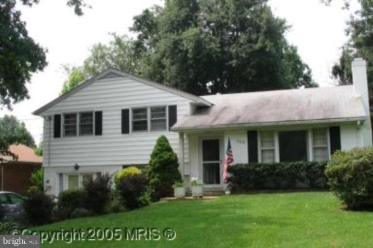 5218 Cather Road Springfield, VA 22151 - Photo 1 of 1 a front view of a house with a garden and plants