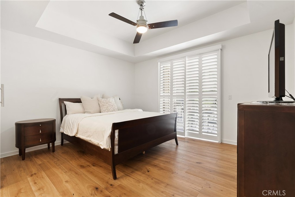 21 Gramercy, Unit 102 Irvine, CA 92612 - Photo 15 of 30 Spacious primary suite with large windows, balcony access, designer touches, and relaxing ambiance.