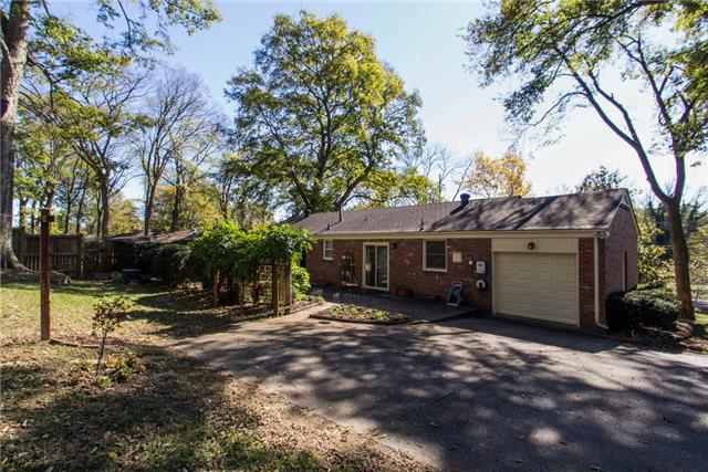 636 Hogan Road Nashville, TN 37220 - Photo 14 of 14 Another view of the backyard shows the garage- this garage hosts the washer and dryer and leads the way to a massive attic- perfect for storage!