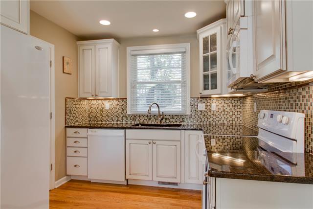 636 Hogan Road Nashville, TN 37220 - Photo 6 of 14 The kitchen overlooks the gorgeous backyard and garden. Look at those countertops!