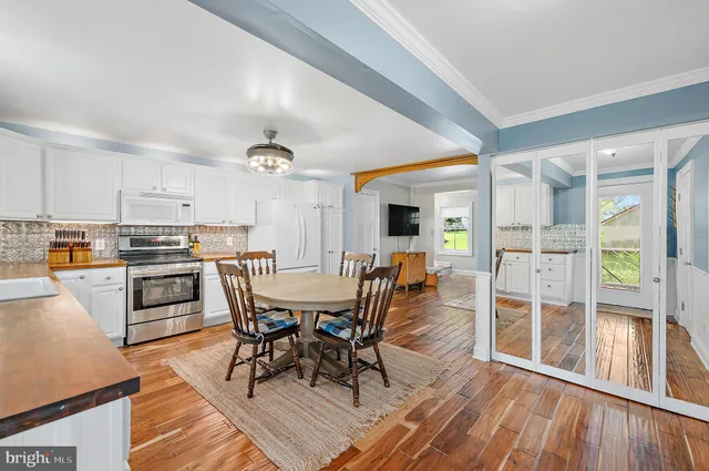 a bedroom with a bed and a flat tv screen on dresser