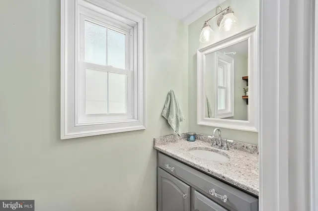 a view of a room with a large window and wooden floor