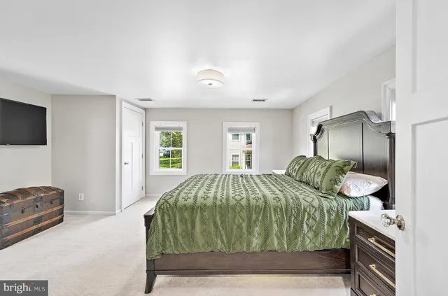 a spacious bathroom with a granite countertop sink and a window