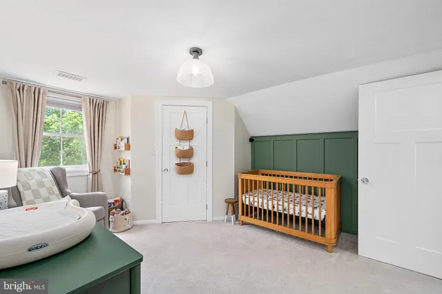 a view of a big house with a big yard and large trees