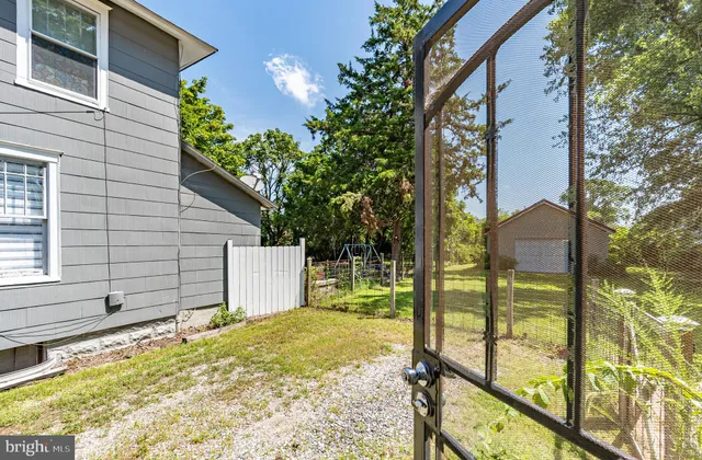 a view of a backyard with table and chairs under an umbrella
