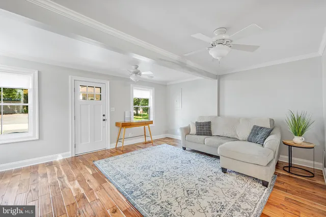 a kitchen with stainless steel appliances granite countertop a dining table chairs refrigerator and sink