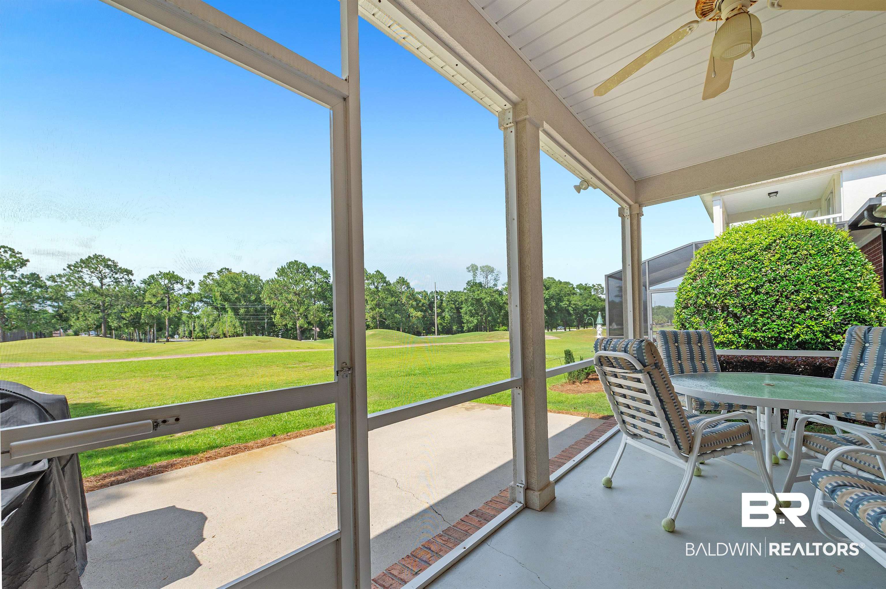 22739 Inverness Way Foley, AL 36535 - Photo 14 of 80 Sunroom featuring a ceiling fan, view of wooded area, and view of golf course