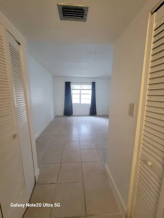 a view of a hallway with wooden shelves