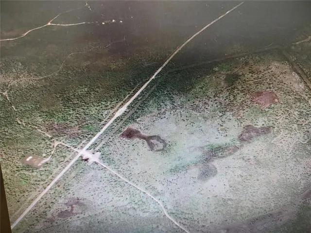 a view of a stone wall with a bench