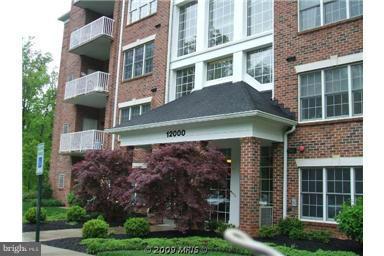 12000 Tralee Road, Unit 302 Lutherville-Timonium, MD 21093 - Photo 26 of 28 a view of building with a yard and potted plants