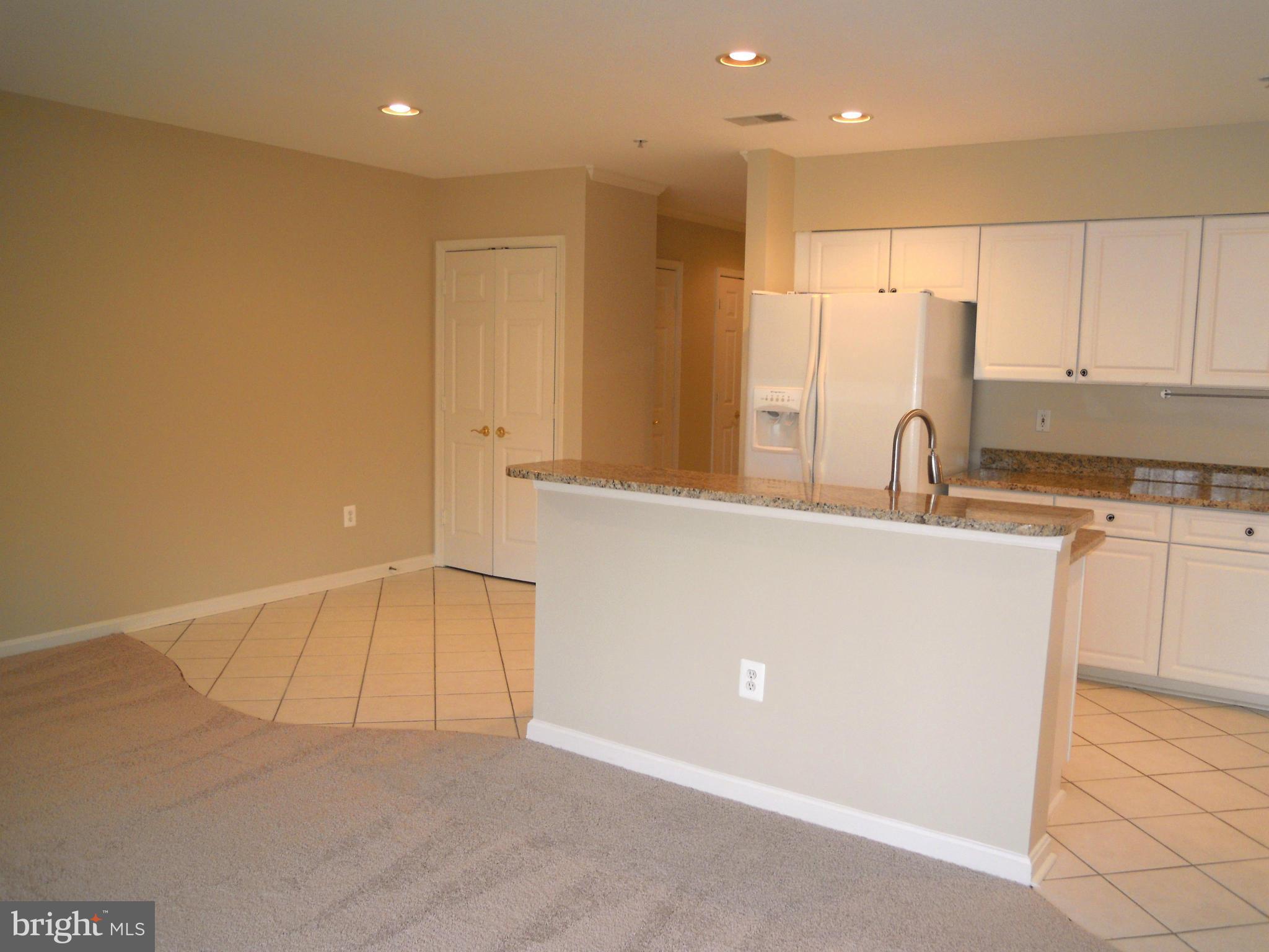 12000 Tralee Road, Unit 302 Lutherville-Timonium, MD 21093 - Photo 7 of 28 a kitchen with a sink cabinets and a refrigerator