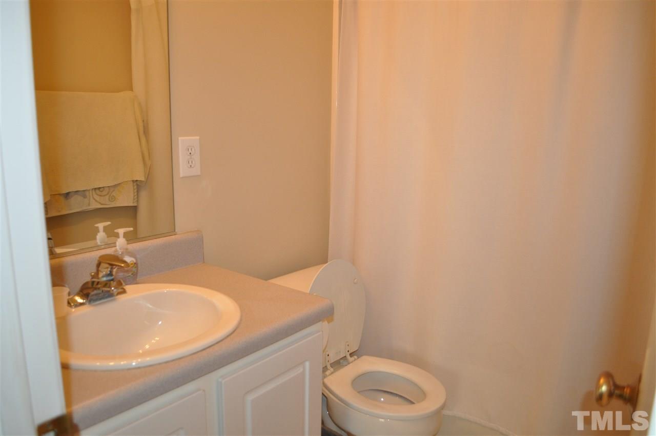 4904 Mocha Lane Raleigh, NC 27616 - Photo 12 of 15 a bathroom with a sink a toilet and a mirror
