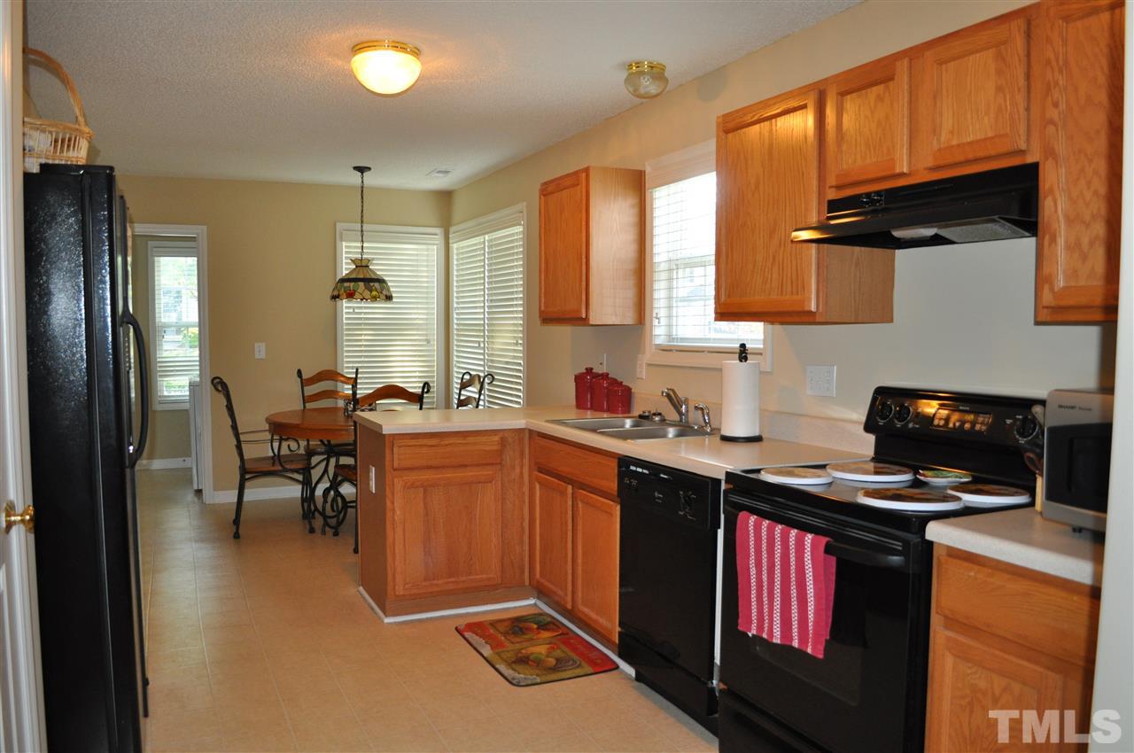 4904 Mocha Lane Raleigh, NC 27616 - Photo 5 of 15 a kitchen with a sink stove and cabinets