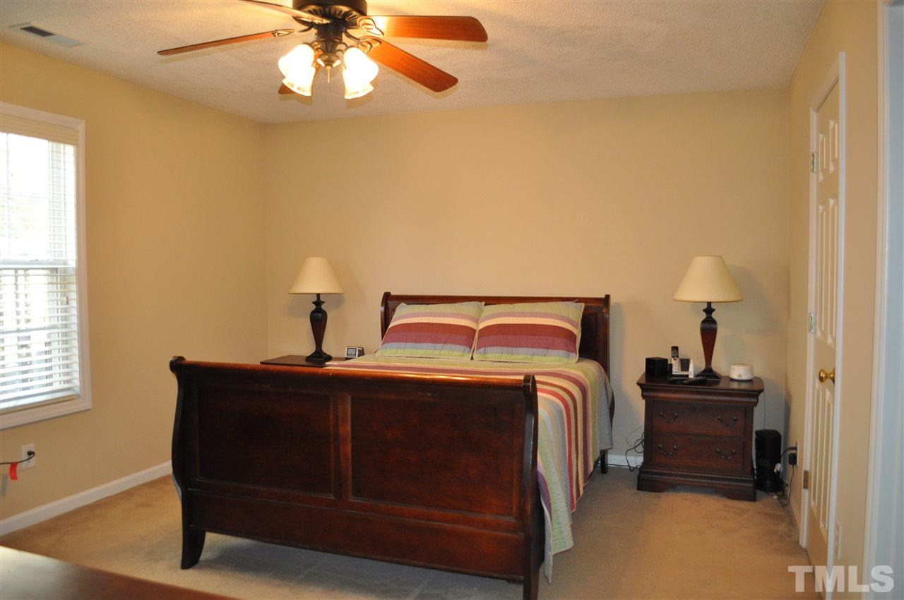 4904 Mocha Lane Raleigh, NC 27616 - Photo 8 of 15 a bedroom with a bed and a chandelier