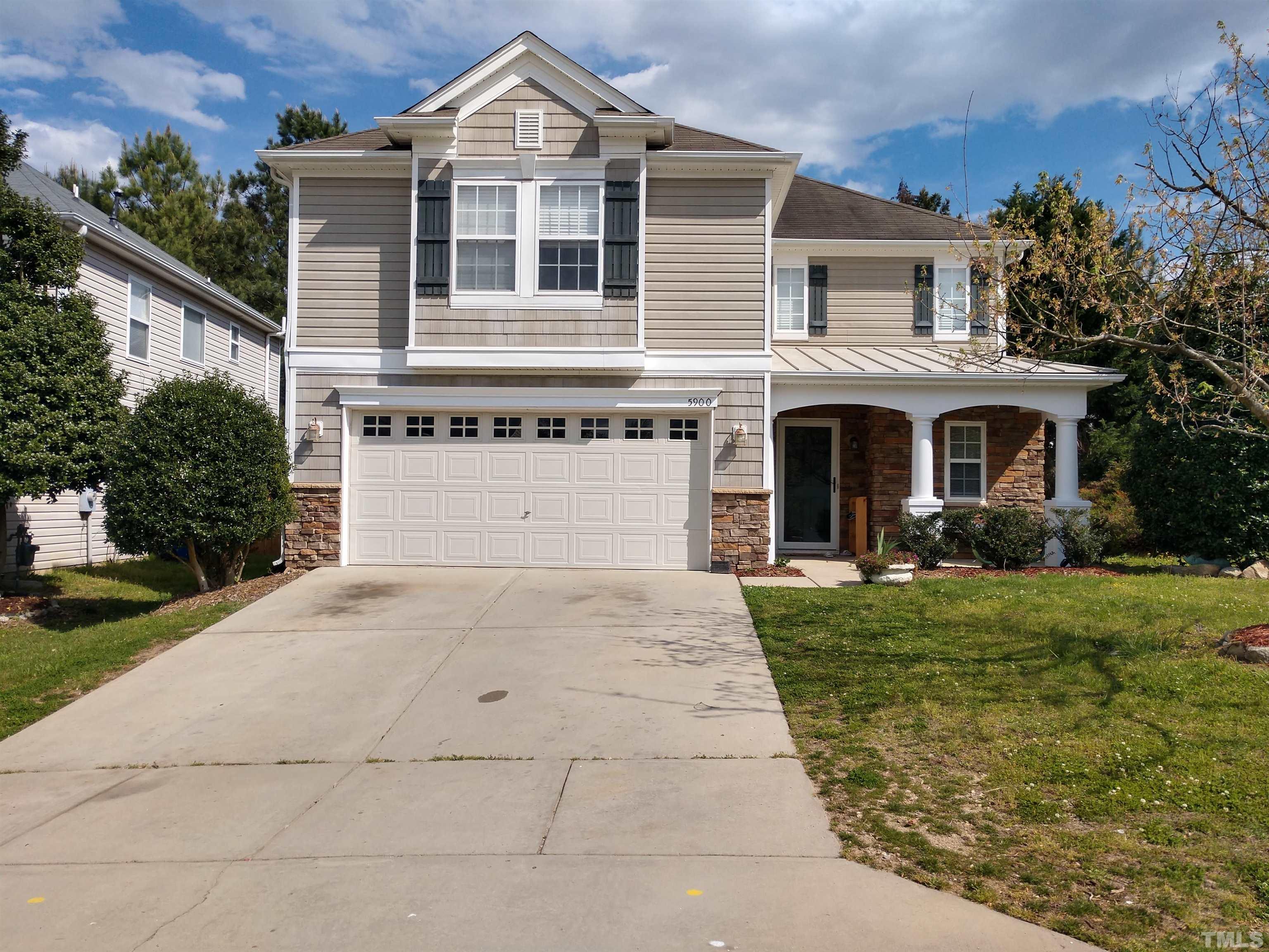 5900 Ricker Road Raleigh, NC 27610 - Photo 1 of 3 a front view of a house with a yard and garage