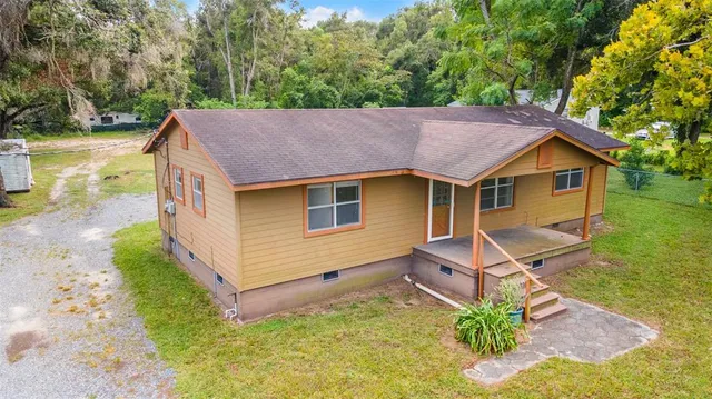 a aerial view of a house with a yard