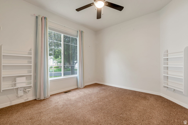 1092 Tithing Ridge Drive Riverton, UT 84065 - Photo 12 of 25 guest bedroom with large end unit window, ceiling fan and large closet with organizer