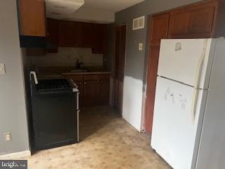 2007 Dineen Drive Baltimore, MD 21222 - Photo 3 of 12 a view of storage and utility room with refrigerator and washer