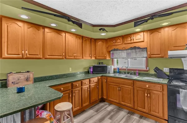 a kitchen with a sink and wooden cabinets