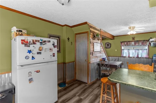 a kitchen with a refrigerator and a table