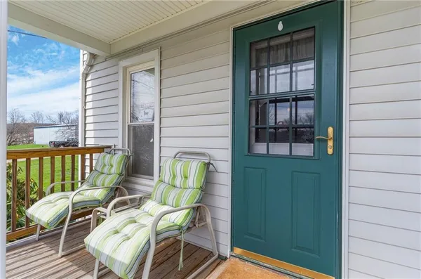 a balcony with furniture and next to a window