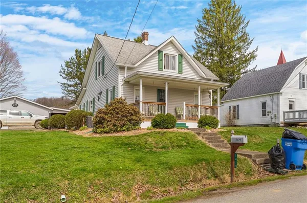 a front view of house with yard and green space