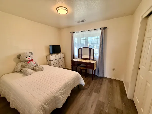 a bedroom with a bed and a tv