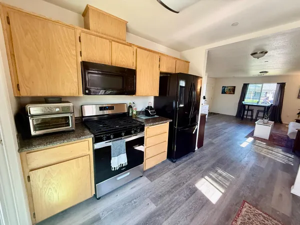 a kitchen with stainless steel appliances a stove microwave and a refrigerator