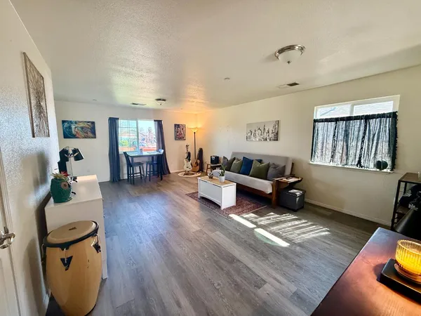 a living room with furniture and wooden floor