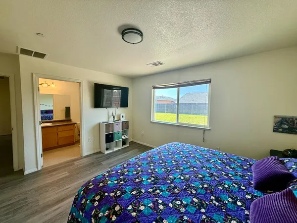 a bedroom with a bed and a television