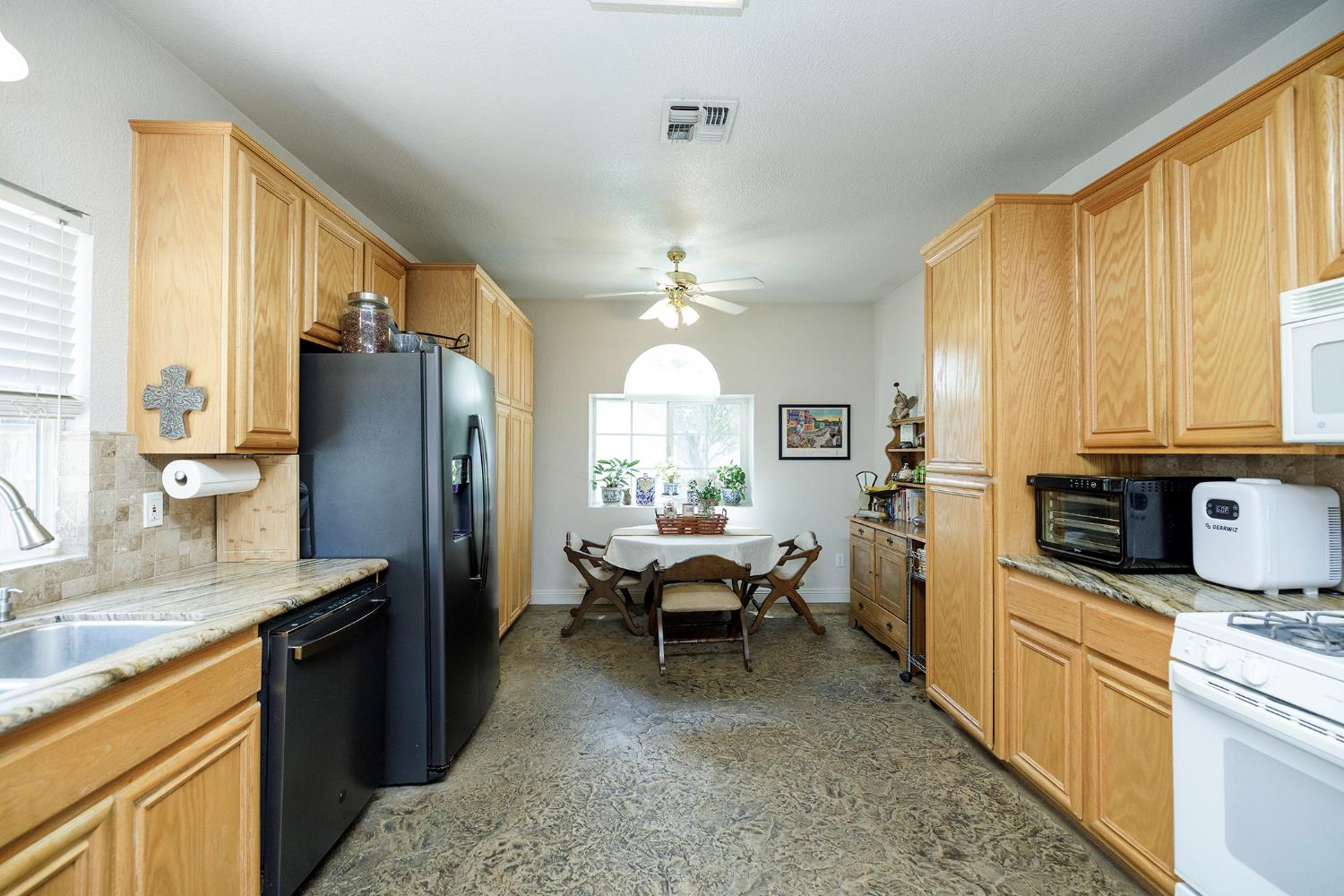 3731 Incline Way Riverbank, CA 95367 - Photo 16 of 49 a kitchen with refrigerator a stove a sink dishwasher and cabinets with wooden floor