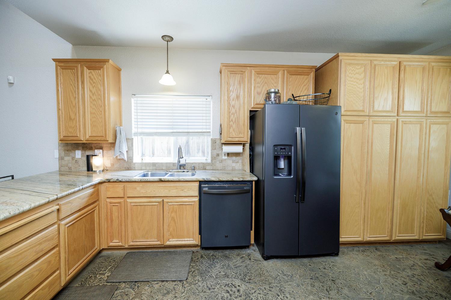 3731 Incline Way Riverbank, CA 95367 - Photo 17 of 49 a kitchen with stainless steel appliances granite countertop a refrigerator and a sink