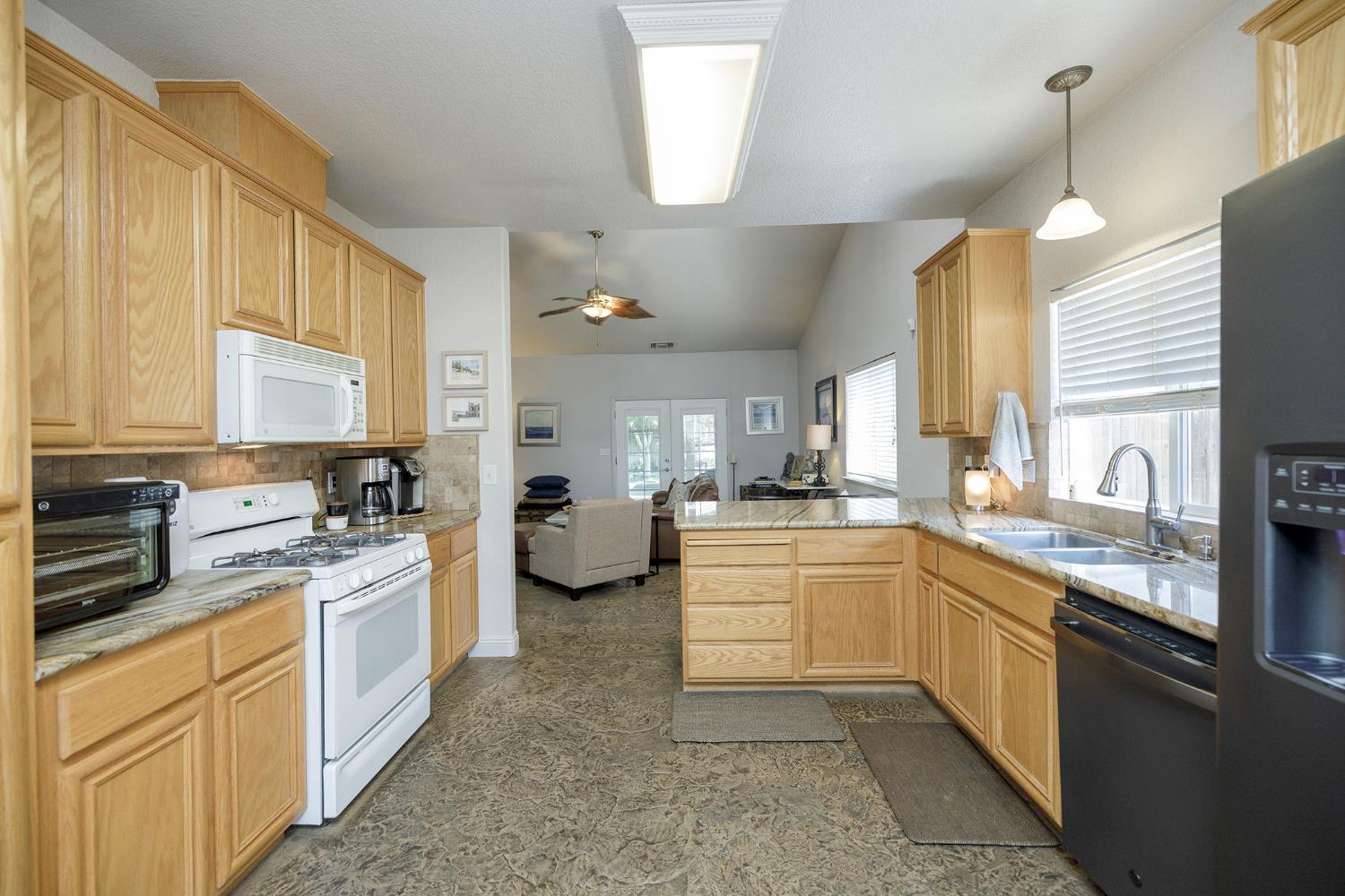 3731 Incline Way Riverbank, CA 95367 - Photo 19 of 49 a kitchen with a sink stove and cabinets
