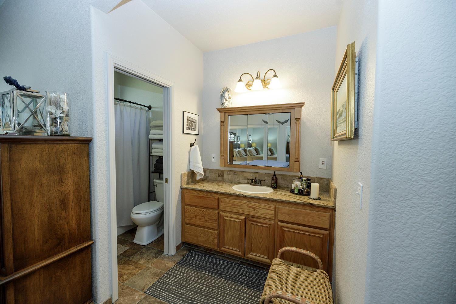 3731 Incline Way Riverbank, CA 95367 - Photo 23 of 49 a spacious bathroom with a toilet sink and mirror