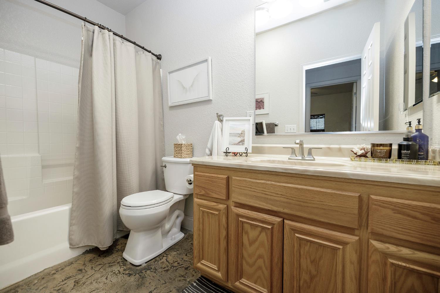 3731 Incline Way Riverbank, CA 95367 - Photo 27 of 49 a bathroom with a sink toilet and shower