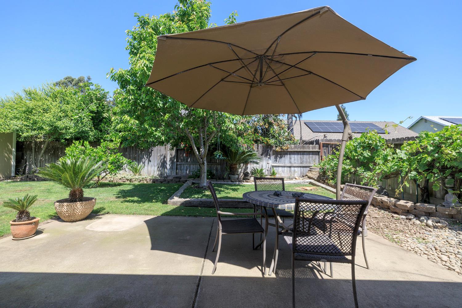 3731 Incline Way Riverbank, CA 95367 - Photo 36 of 49 a view of patio with chairs and table under an umbrella