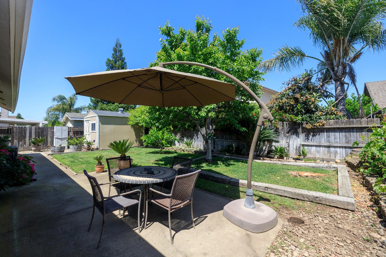 3731 Incline Way Riverbank, CA 95367 - Photo 37 of 49 a view of a table and chairs under an umbrella in backyard