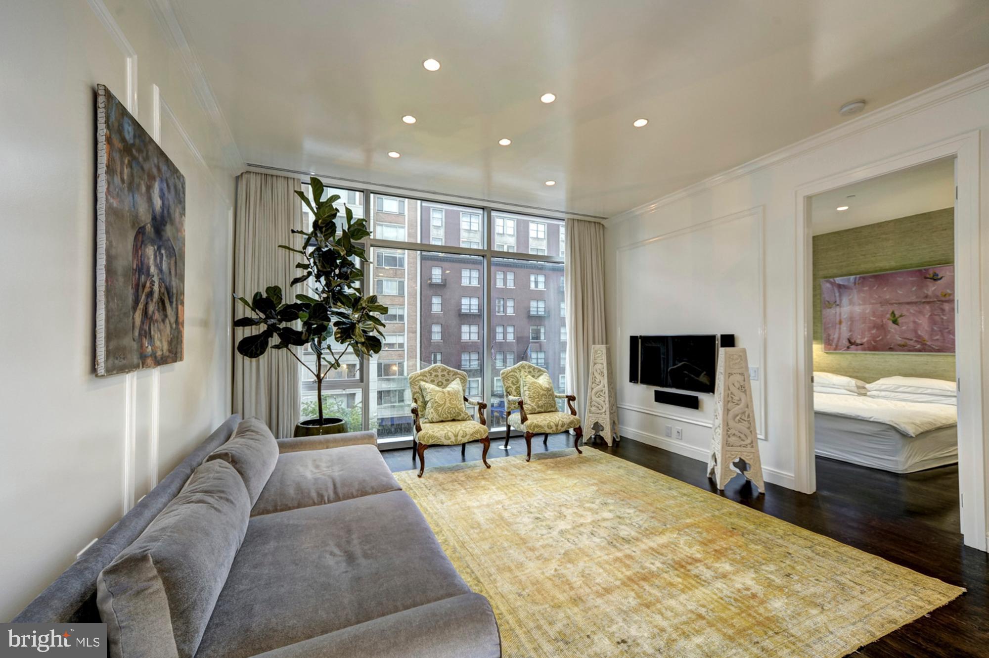 1177 22nd Street Northwest, Unit 3H Washington, DC 20037 - Photo 4 of 17 a living room with furniture and a flat screen tv