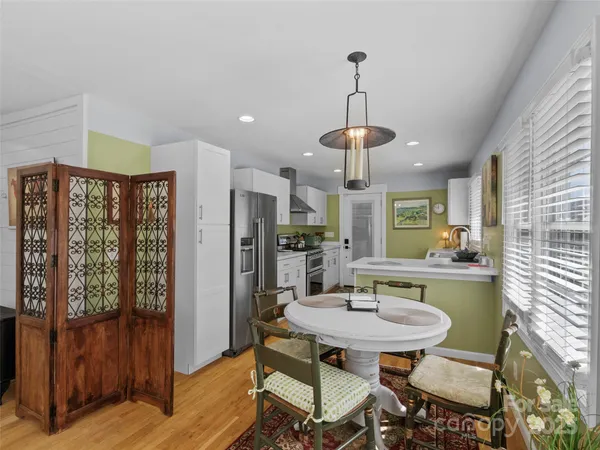 a view of a dining room with furniture window and wooden floor