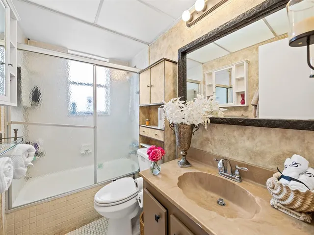 a bathroom with a sink toilet tub and shower