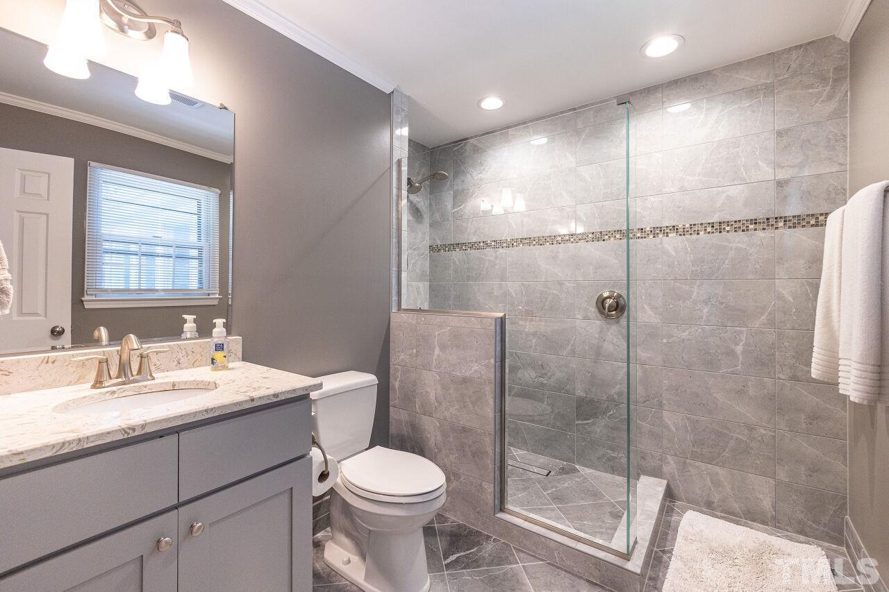 4808 Waybridge Court Raleigh, NC 27606 - Photo 20 of 29 a bathroom with a toilet sink and shower