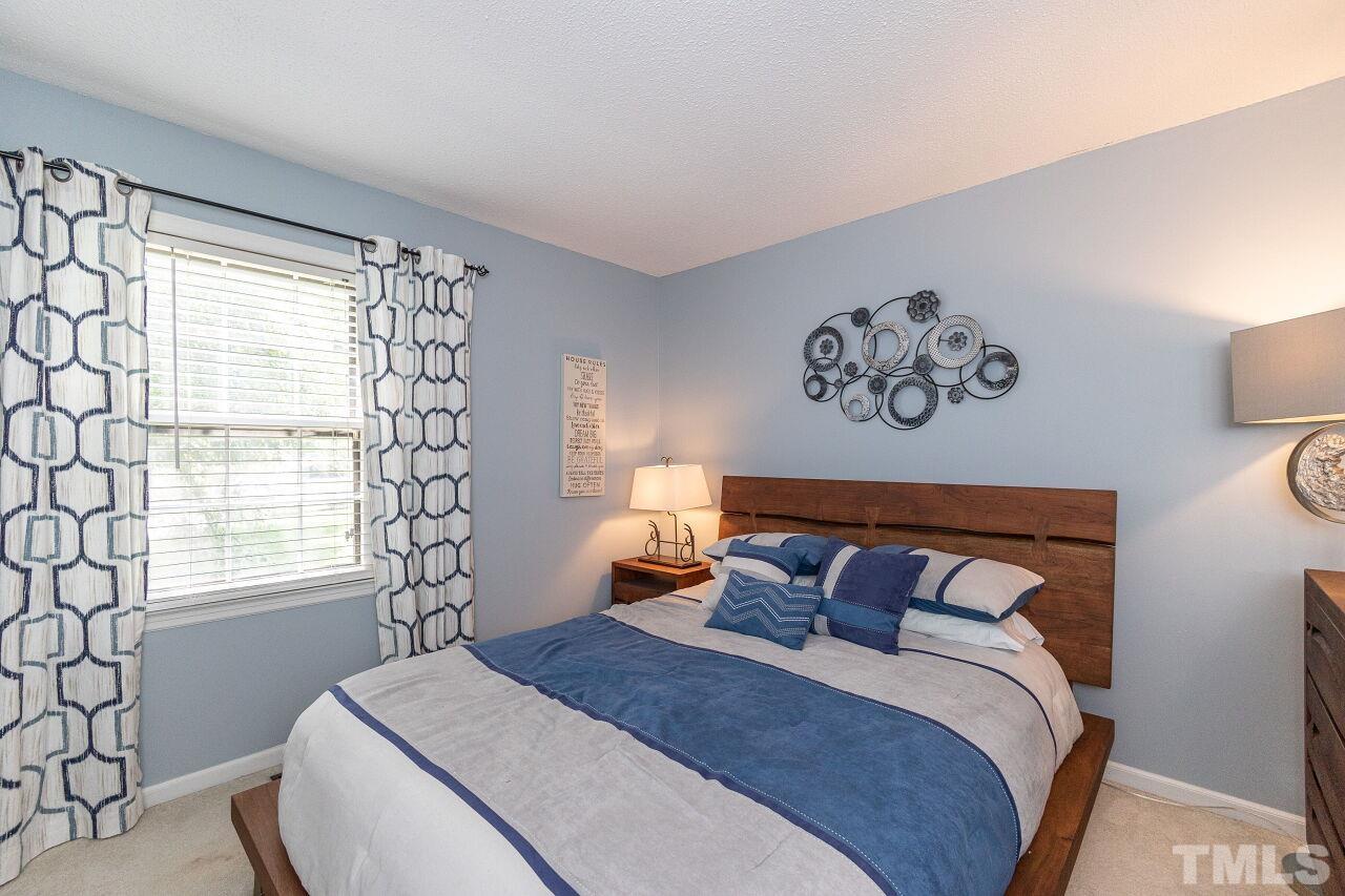 4808 Waybridge Court Raleigh, NC 27606 - Photo 24 of 29 a bedroom with a bed and a window