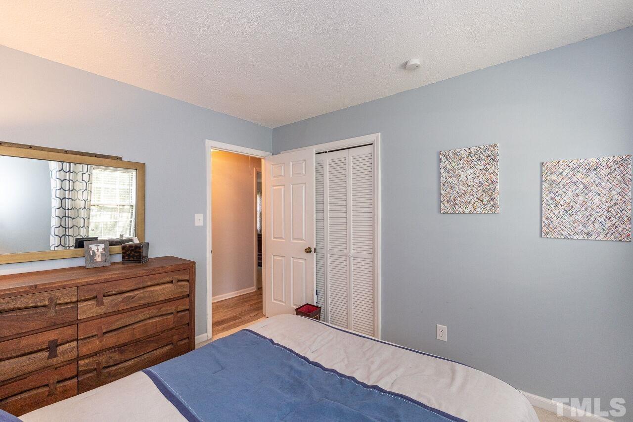 4808 Waybridge Court Raleigh, NC 27606 - Photo 25 of 29 a bed room with a bed and a window