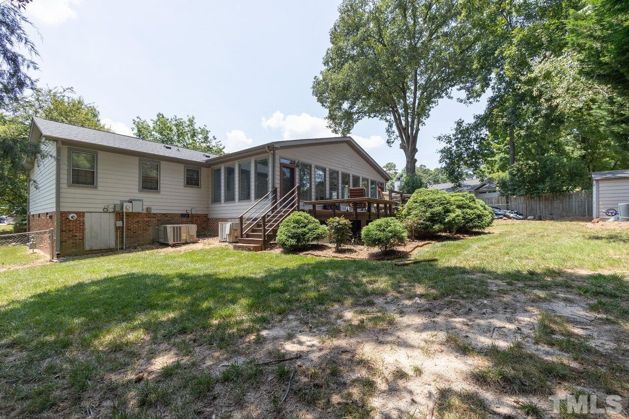 4808 Waybridge Court Raleigh, NC 27606 - Photo 28 of 29 a view of a house with backyard and a tree